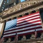 pexels-photo-30915372-30915372 American flag adorning the iconic New York Stock Exchange building facade.