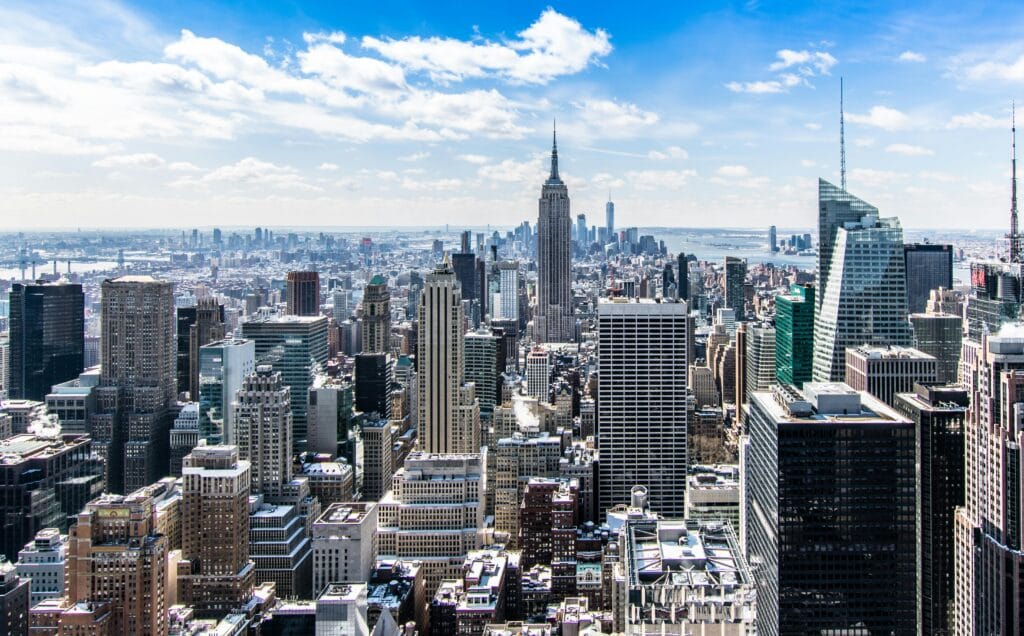 pexels-photo-466685-466685 A stunning aerial view of New York City's skyline featuring the iconic Empire State Building under a bright blue sky.